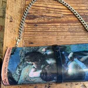 Breeke
  Multi-Color Clutch with Chain Strap.  Hard surface. My favorite